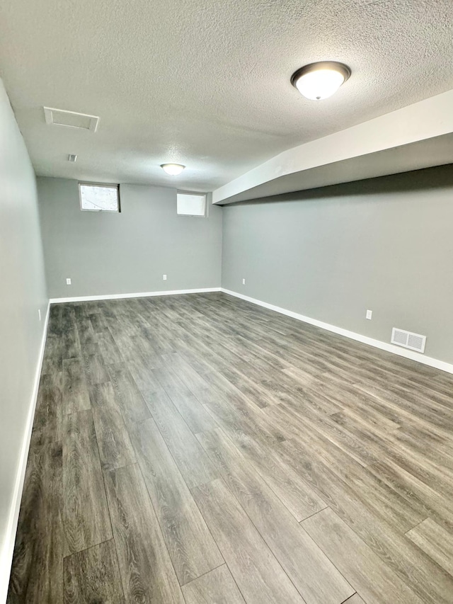 40308 County Road 3, Fifty Lakes, MN 56448 - below grade area featuring wood finished floors and a textured ceiling