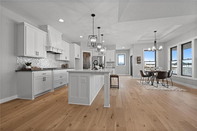 kitchen featuring decorative light fixtures, light hardwood / wood-style floors, and a wealth of natural light