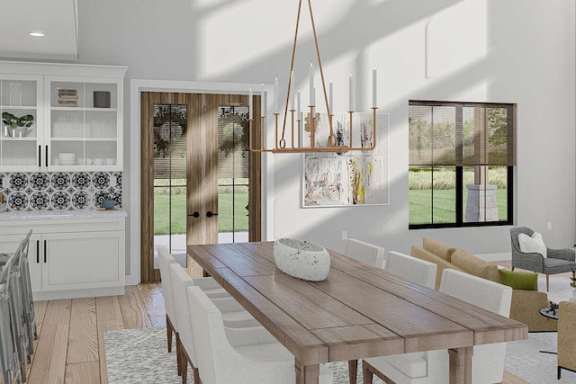 dining area featuring french doors and light hardwood / wood-style flooring