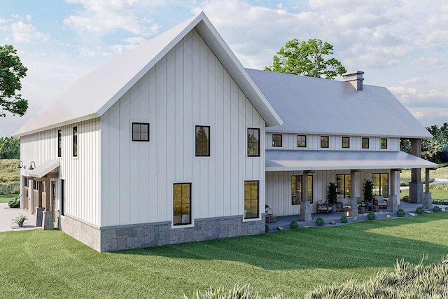 rear view of property featuring a lawn