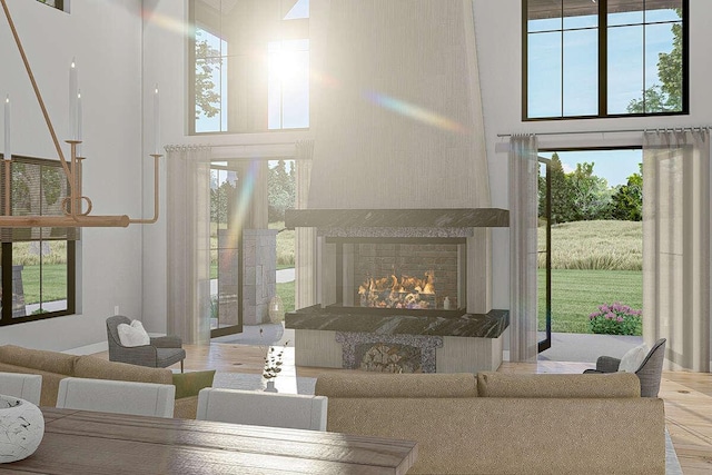 living room with a high ceiling, a large fireplace, and plenty of natural light