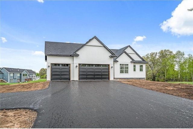 modern inspired farmhouse with a garage