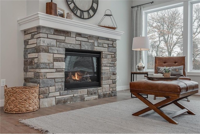 sitting room with hardwood / wood-style floors, plenty of natural light, and a fireplace