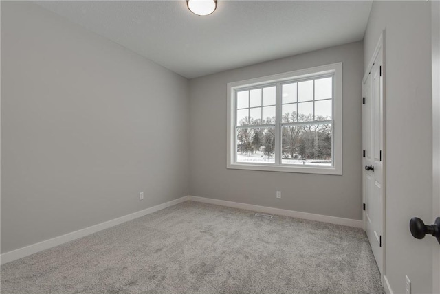 empty room with light colored carpet