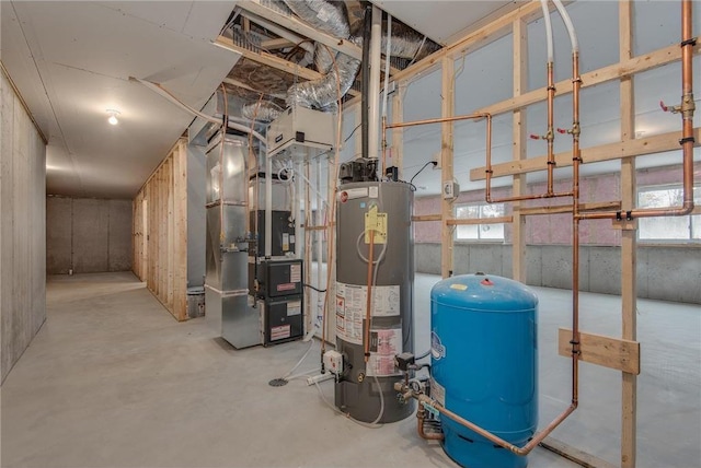 utility room featuring heating unit and gas water heater