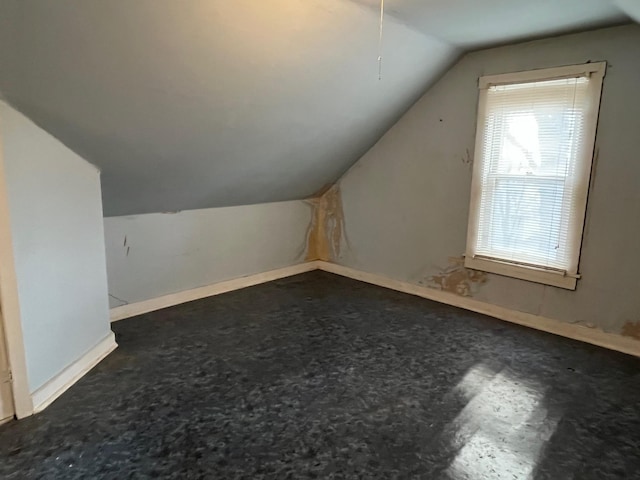 additional living space featuring lofted ceiling