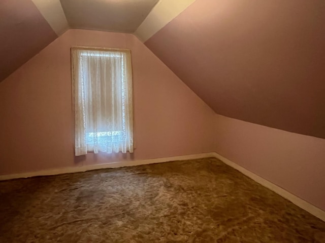 bonus room featuring lofted ceiling and carpet floors