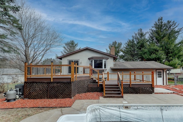 back of house featuring a wooden deck