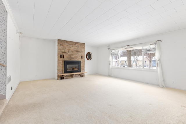 unfurnished living room featuring carpet and a stone fireplace