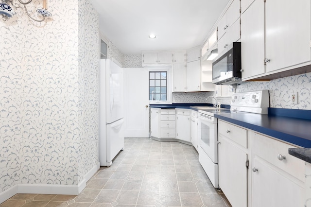 kitchen with white cabinets, white appliances, and sink