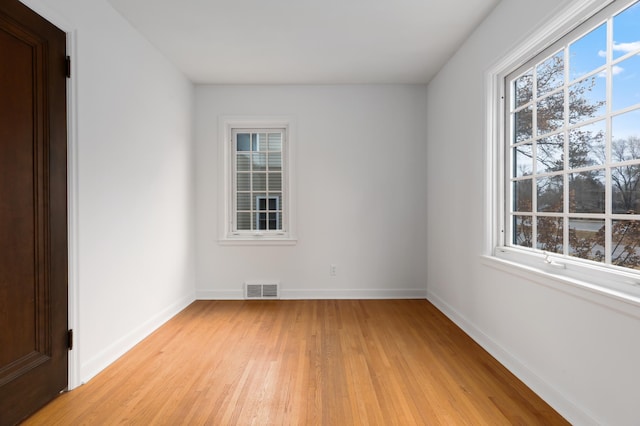 empty room with light hardwood / wood-style floors