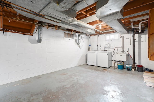 basement featuring sink and washing machine and clothes dryer