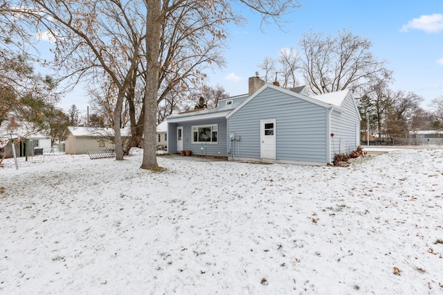 view of snow covered rear of property