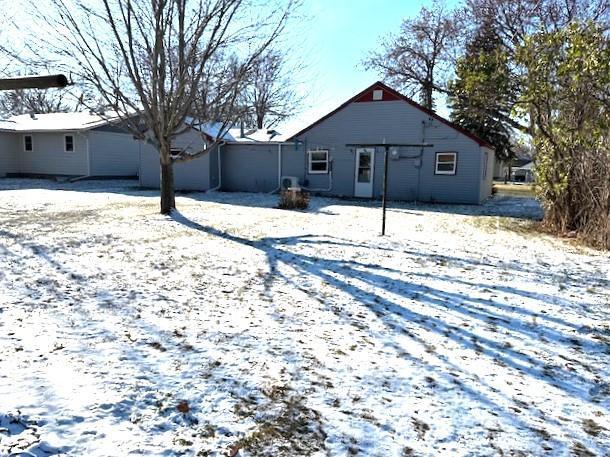 view of snow covered back of property