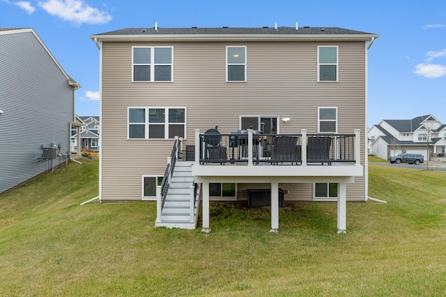 back of property with a deck and a lawn