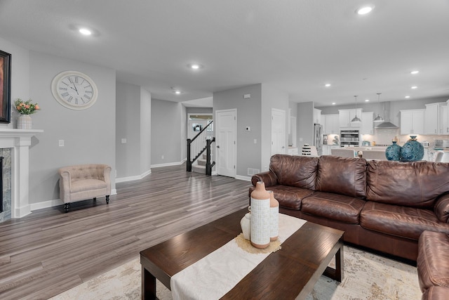 living room featuring a fireplace and light hardwood / wood-style flooring