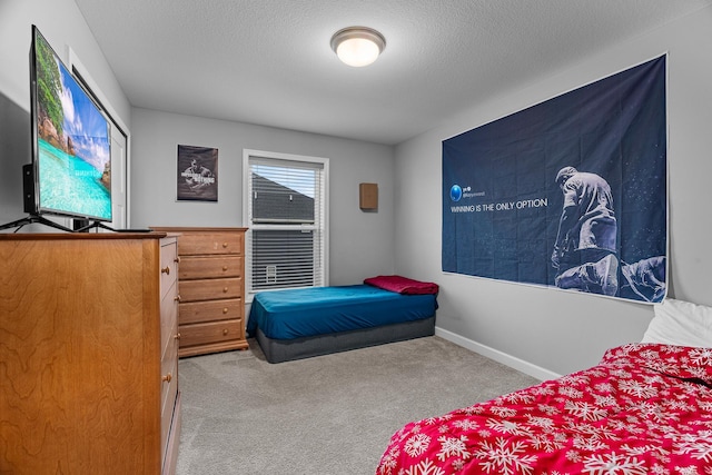 bedroom with carpet floors and a textured ceiling