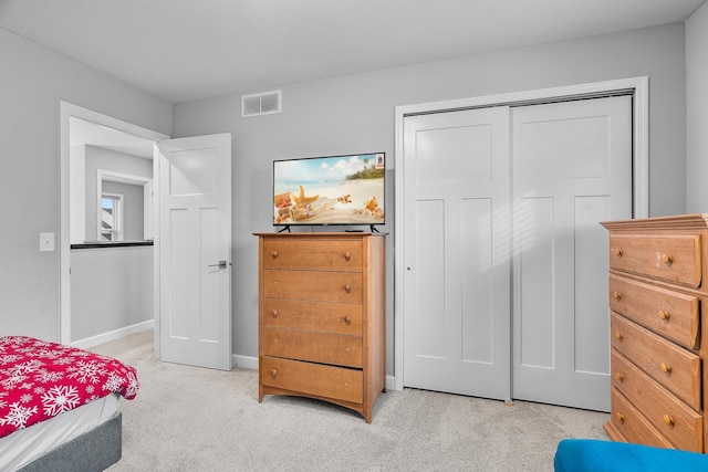 carpeted bedroom featuring a closet