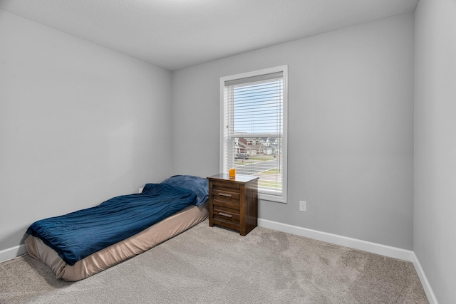 bedroom featuring light carpet