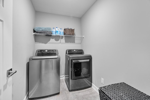 clothes washing area with washer and dryer