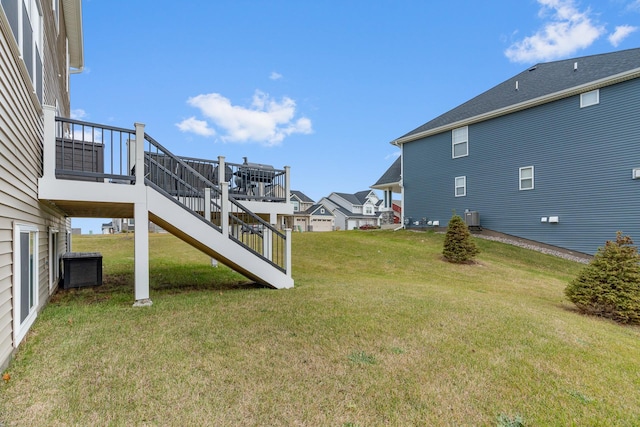 view of yard featuring a wooden deck and central AC