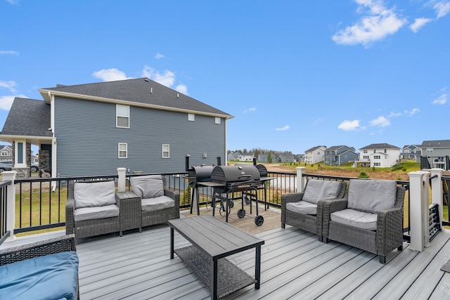 deck with a grill, an outdoor living space, and a water view