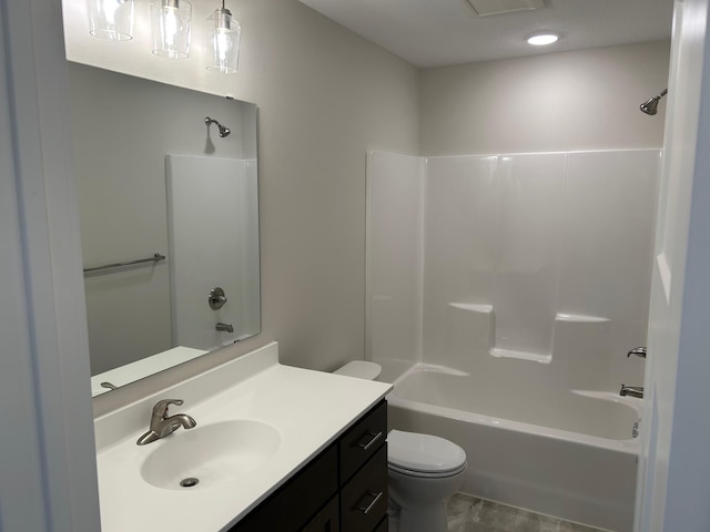 full bathroom featuring vanity, bathing tub / shower combination, and toilet