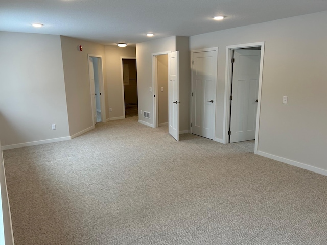 unfurnished bedroom featuring light carpet