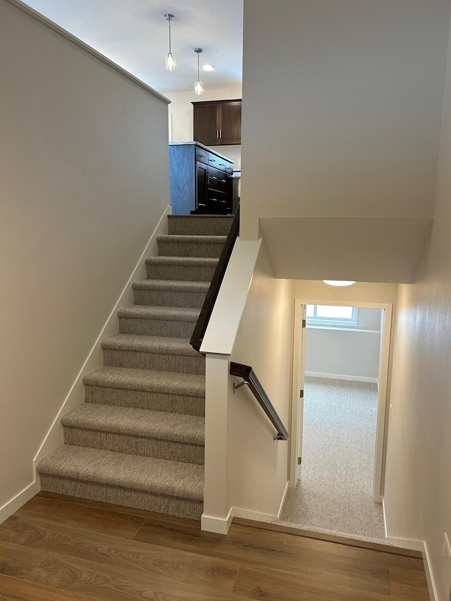 stairs with wood-type flooring