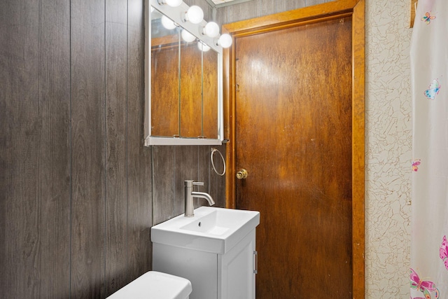 bathroom featuring vanity and toilet