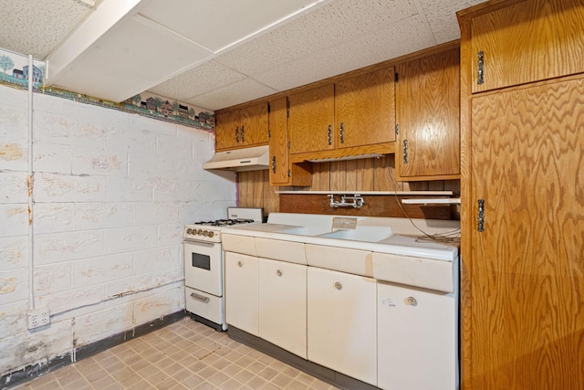 kitchen with white gas range and light tile patterned floors