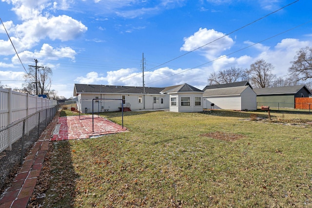 back of house featuring a lawn and a patio