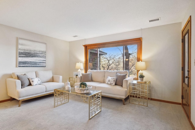 carpeted living room featuring a textured ceiling