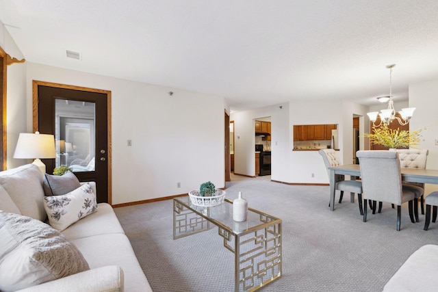 carpeted living room with a chandelier