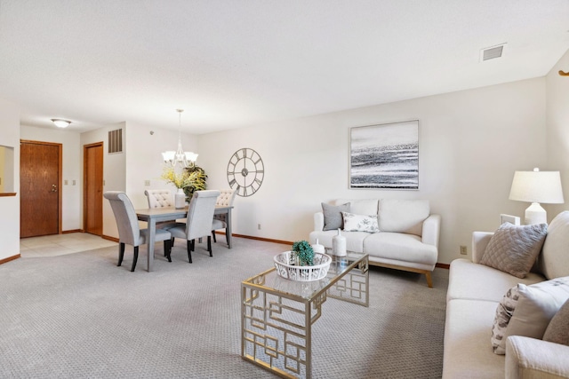 living room with light carpet and a chandelier