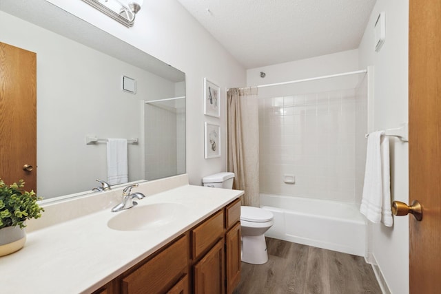 full bathroom featuring shower / bathtub combination with curtain, wood-type flooring, a textured ceiling, toilet, and vanity