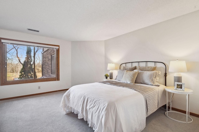 carpeted bedroom with a textured ceiling