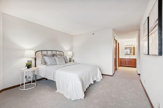 carpeted bedroom featuring connected bathroom and a textured ceiling