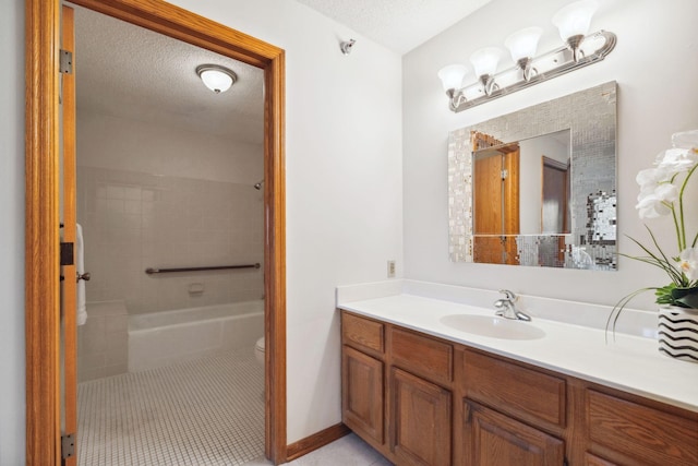 bathroom with vanity, a textured ceiling, and toilet