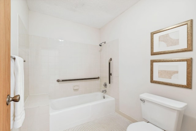 bathroom with tile patterned flooring, toilet, and a textured ceiling