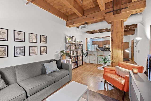 living room with light hardwood / wood-style flooring, beamed ceiling, and wood ceiling