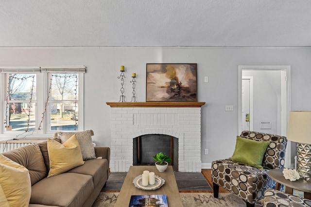 living room with a fireplace, a textured ceiling, and hardwood / wood-style flooring