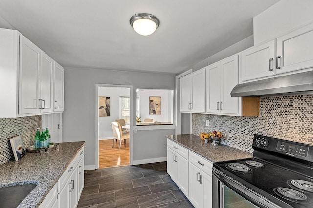 kitchen featuring decorative backsplash, black range with electric stovetop, dark stone counters, dark hardwood / wood-style floors, and white cabinetry