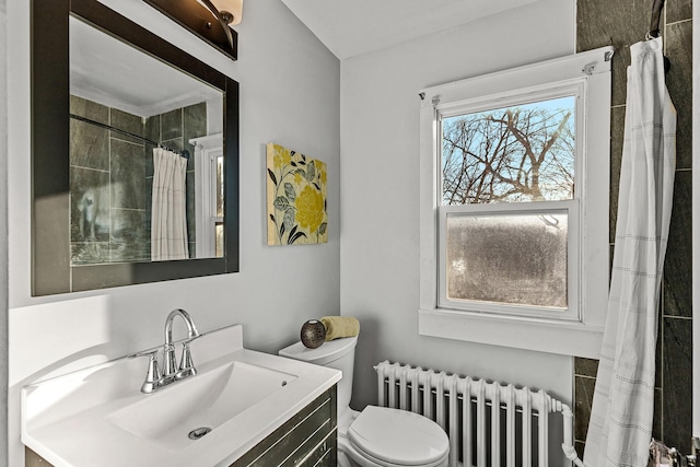 bathroom featuring radiator heating unit, vanity, and toilet