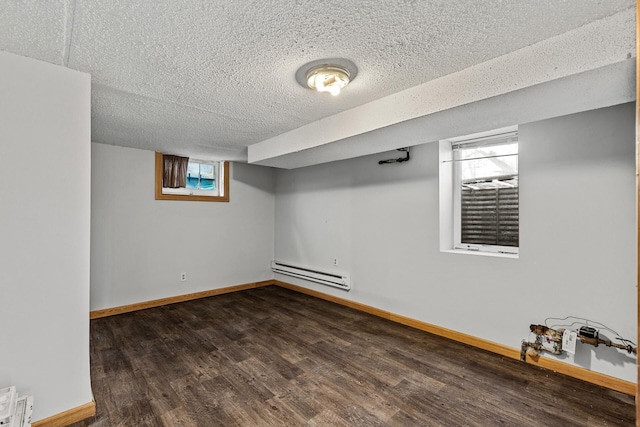 basement featuring dark hardwood / wood-style floors, a textured ceiling, and a baseboard radiator