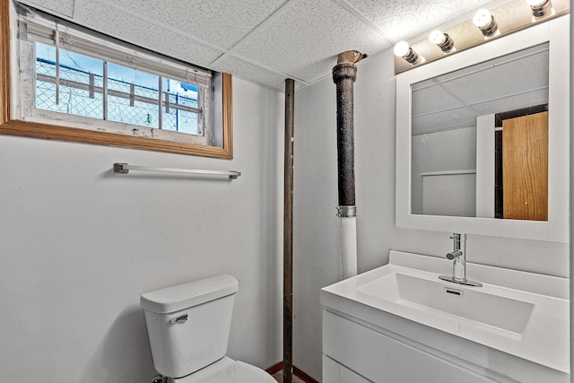 bathroom featuring vanity, a paneled ceiling, and toilet