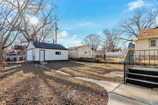 view of yard featuring an outbuilding and a garage