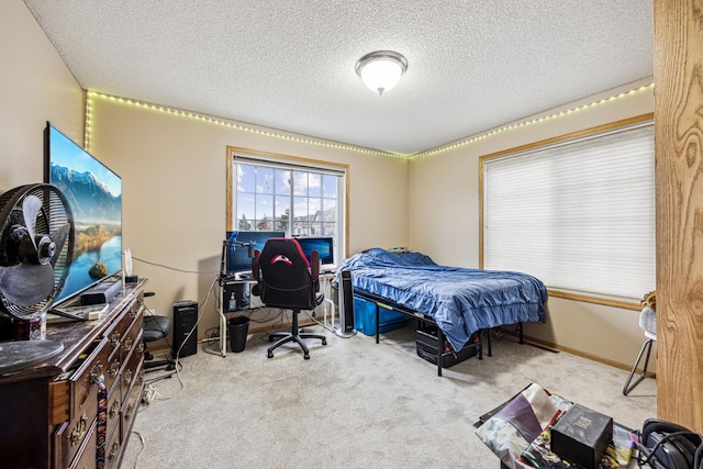 bedroom featuring light carpet and a textured ceiling