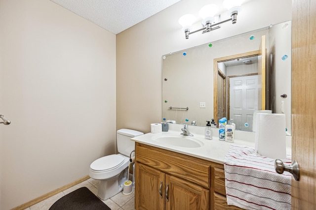 bathroom featuring tile patterned floors, vanity, a textured ceiling, and toilet