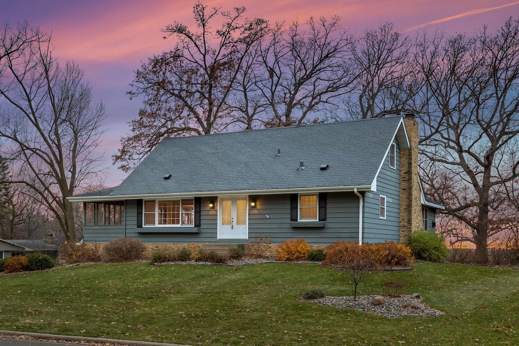 view of front of house featuring a yard and french doors